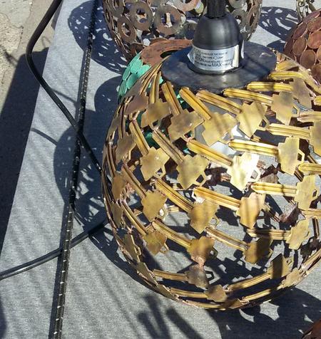 A hanging light assembled from brass offcuts