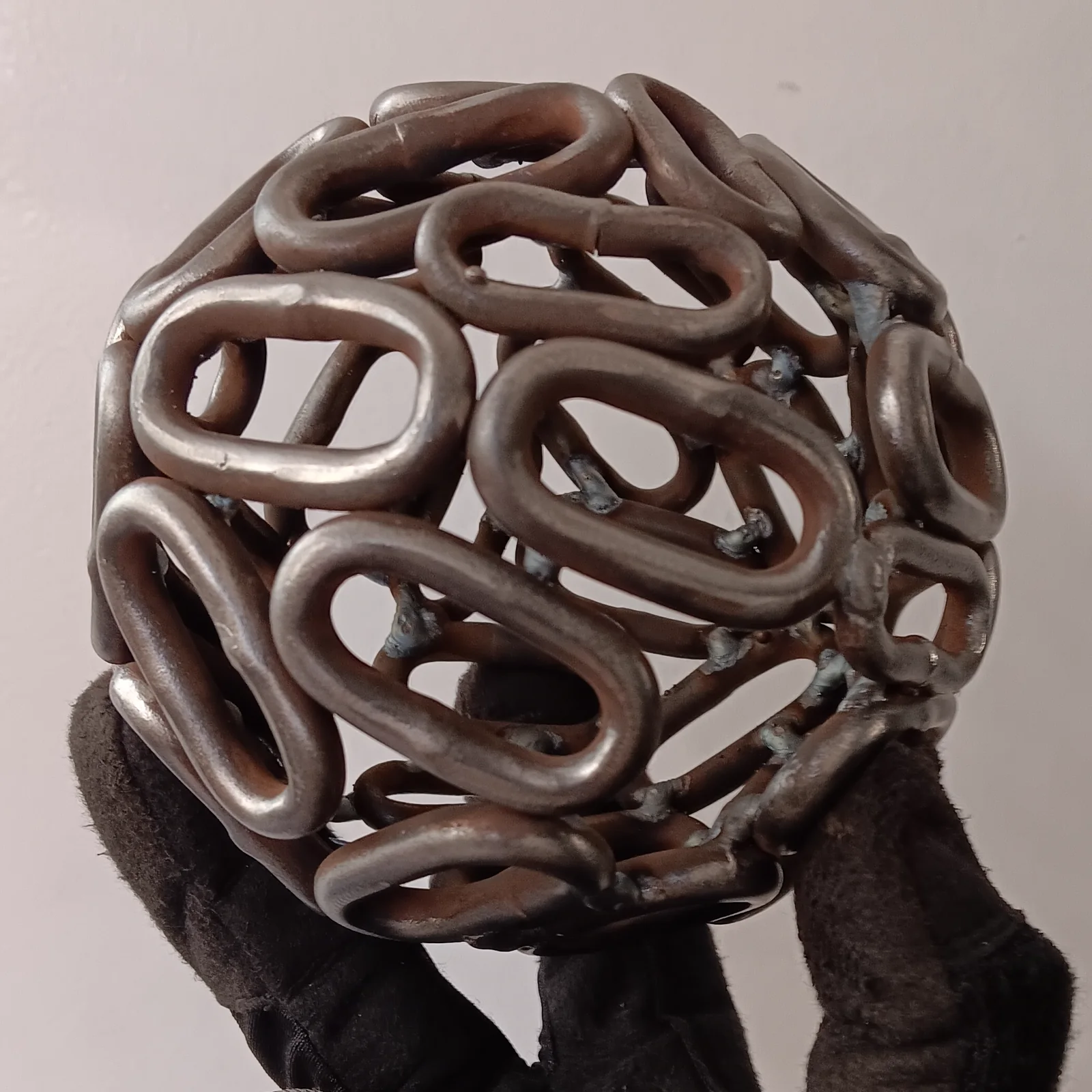 A sphere assembled from loops of reused metal