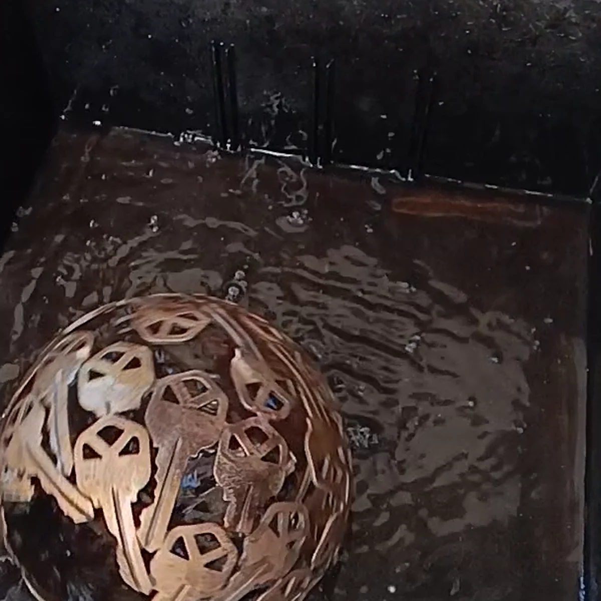 A metal sphere turning through water