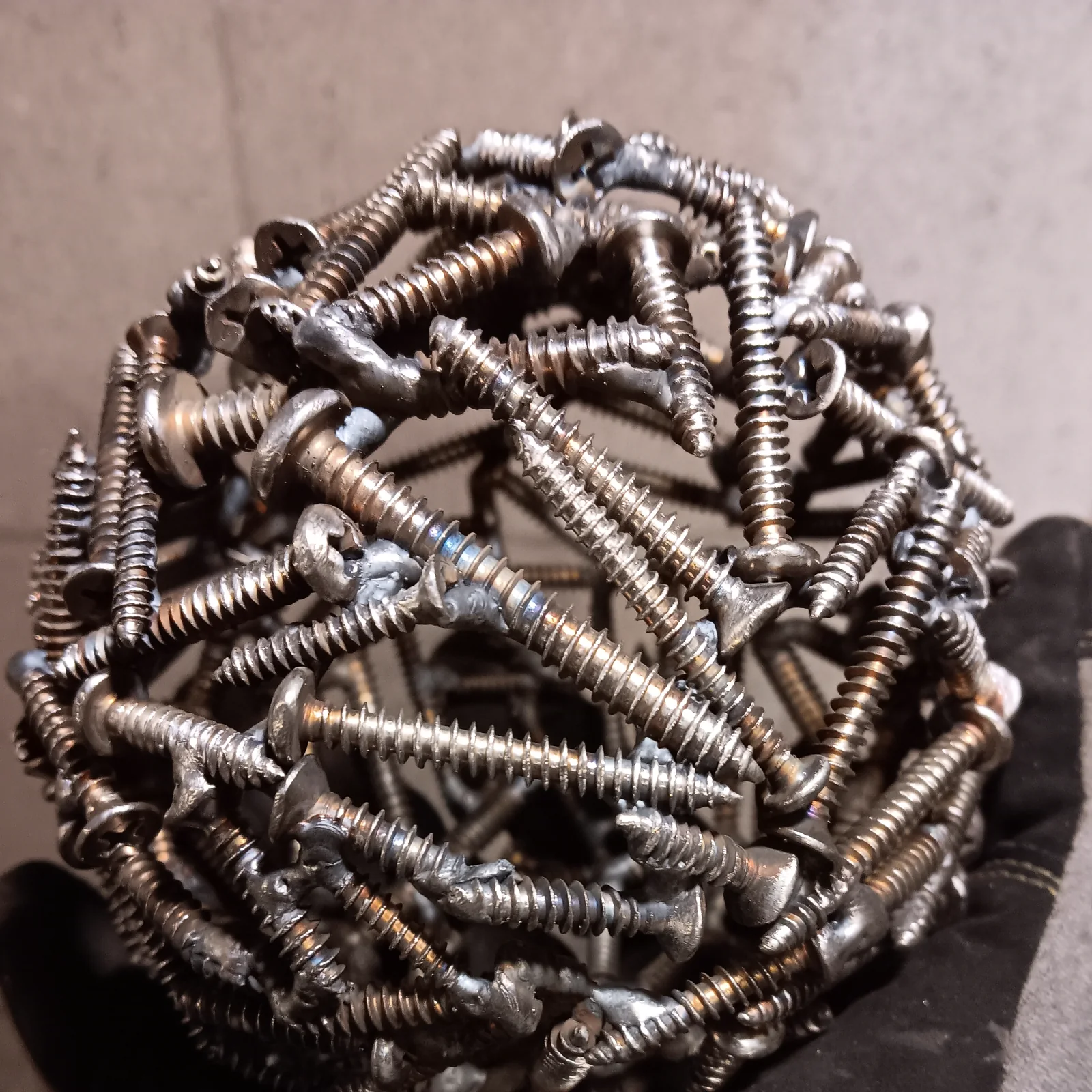 A sphere assembled from reused screws
