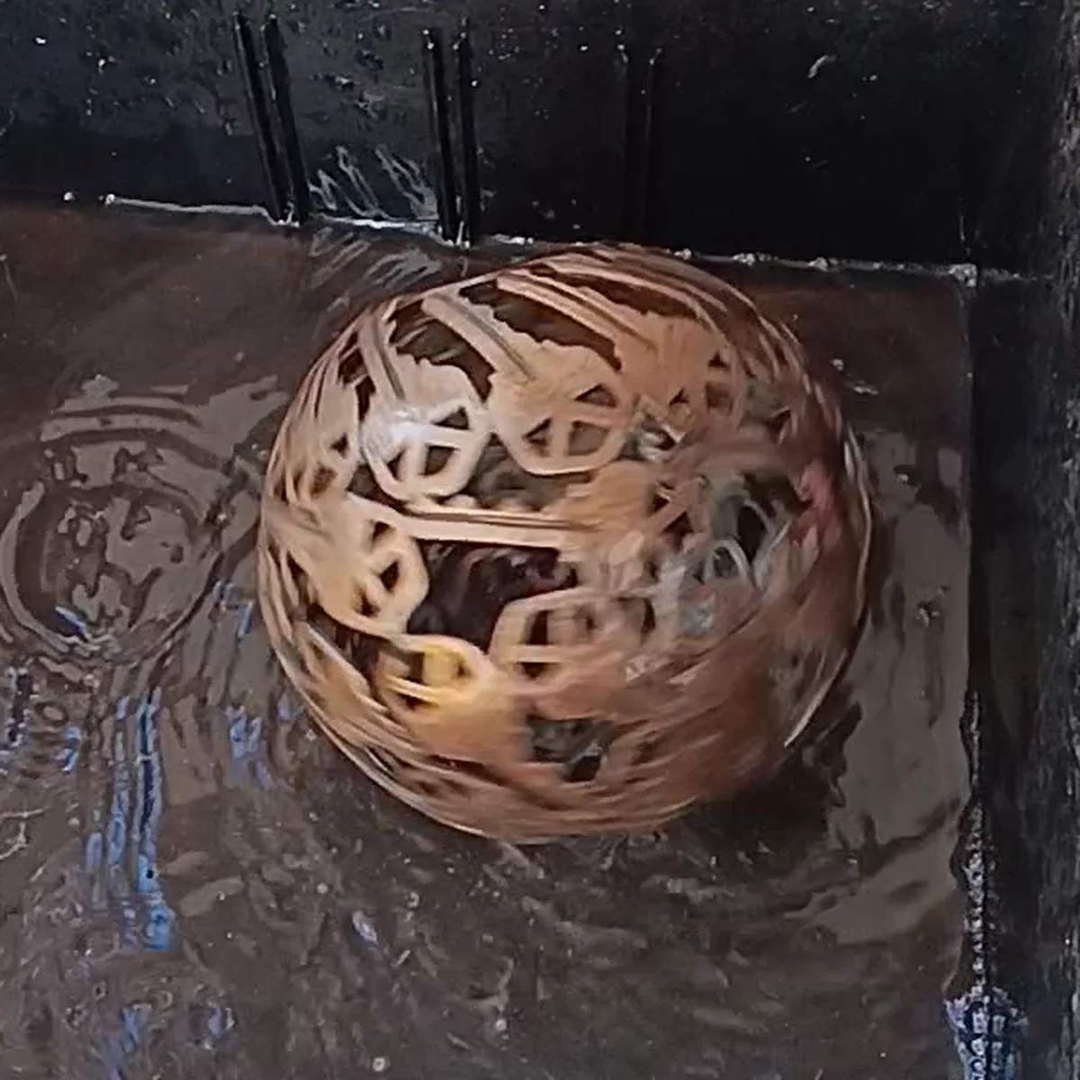 A spinning sphere surrounded by rippling water