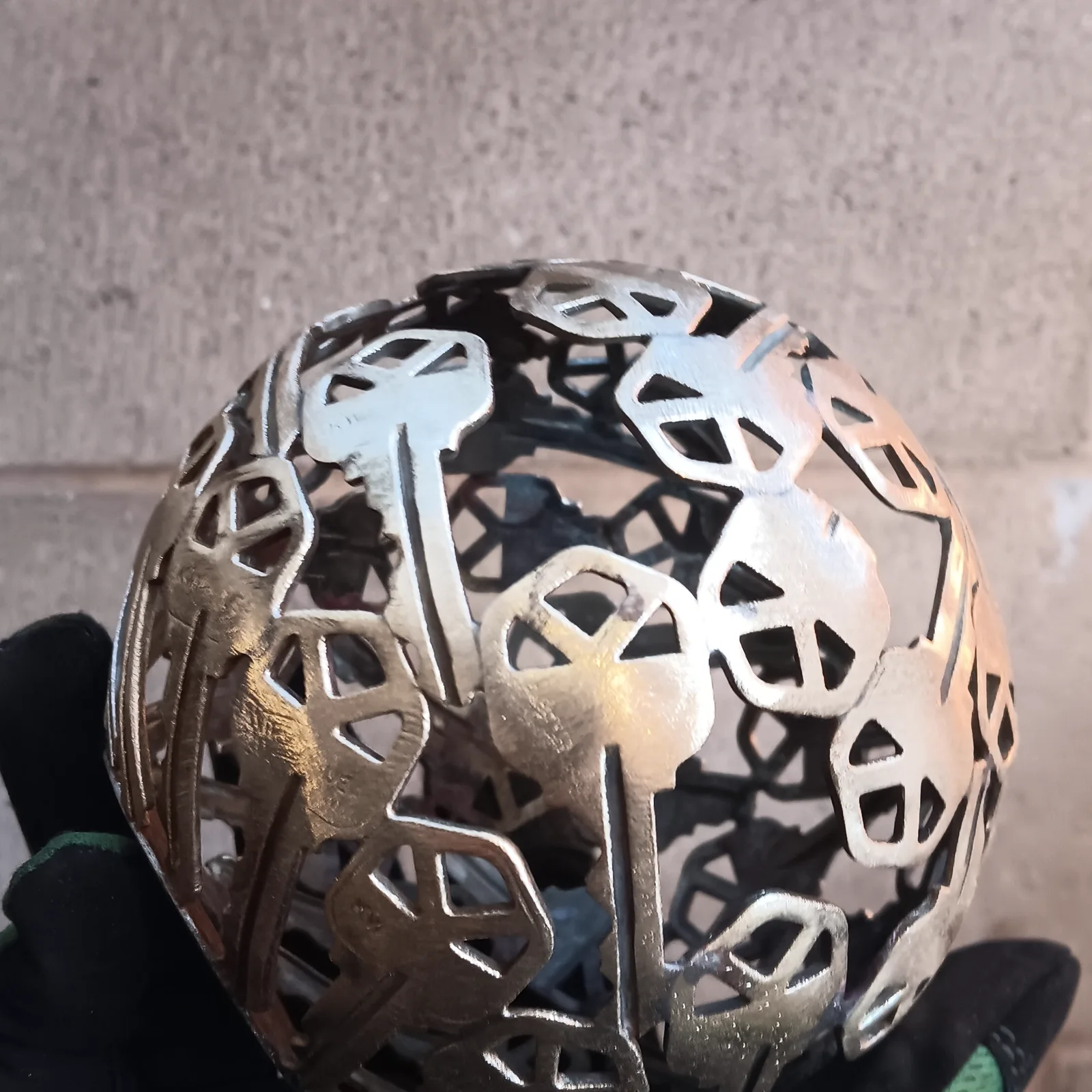 A sphere formed from geometric metal cutouts