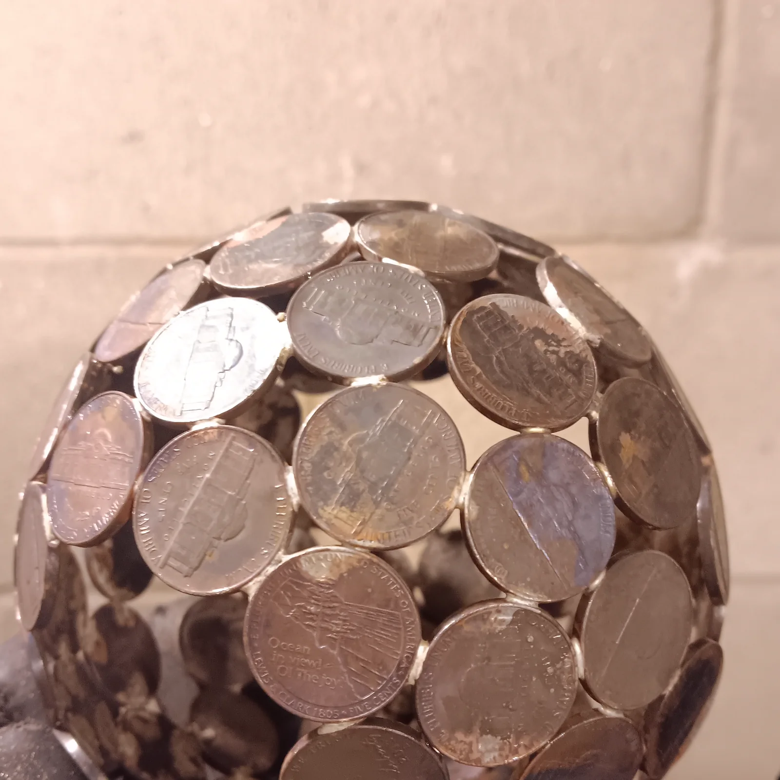 A sphere assembled from reused coins